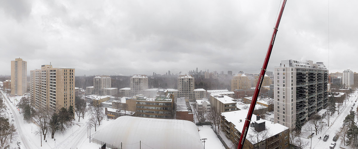 Uniform grey cloud with blowing snow across the middle distance, the skyline pale and low in contrast, deep snow below.