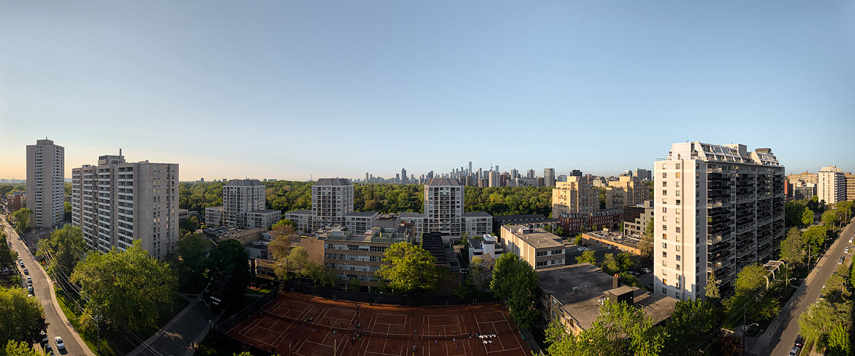 Clean blue sky with the low sun raking across the towers and the skyline sharp on the horizon.