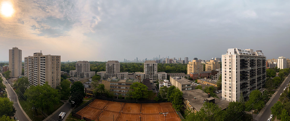 Wildfire smoke fills the sky with yellow grey murk, the sun a dim disc and the skyline reduced to a faint outline.