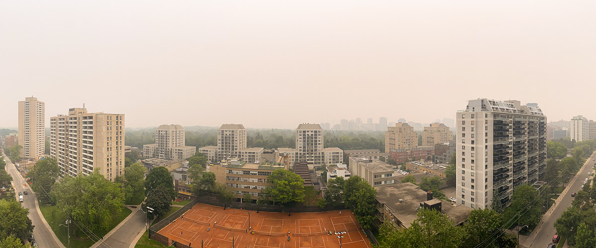 Dense wildfire smoke turns the whole frame tan and the skyline is barely more than a suggestion behind it.