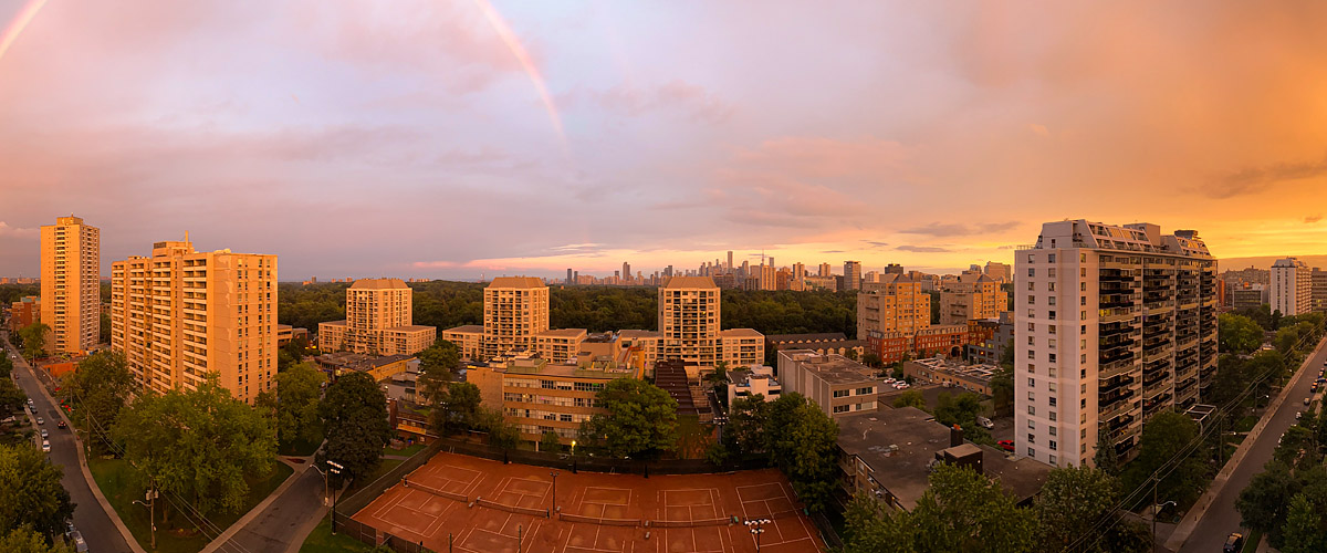 Orange and pink fill the whole sky with a faint rainbow at the left and everything below lit gold.