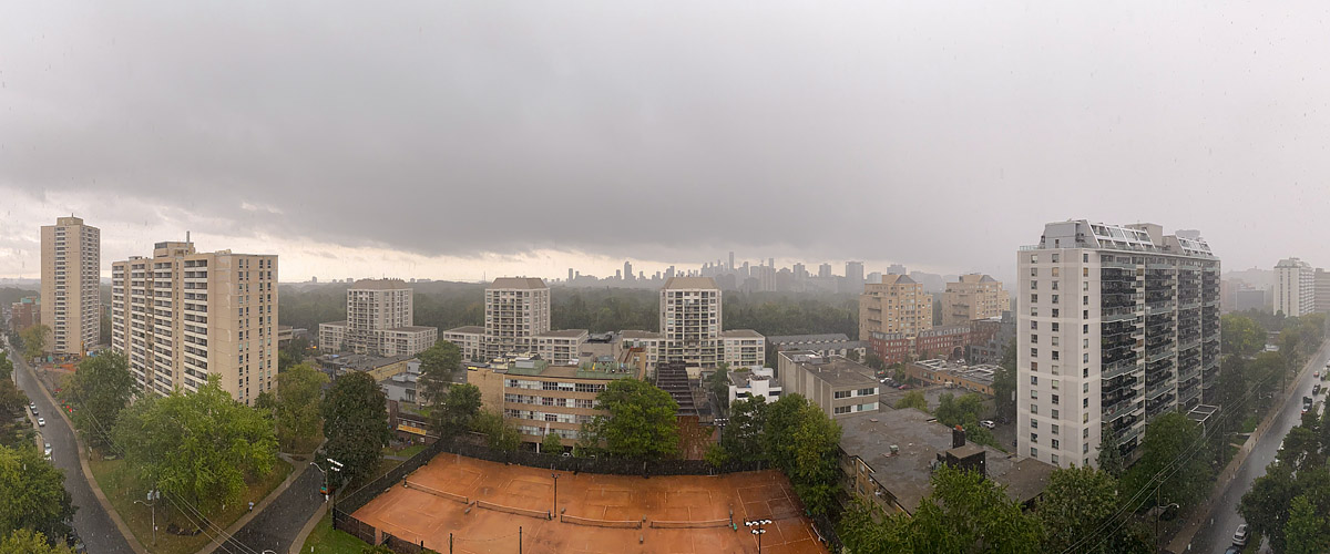 Grey cloud and heavy rain, the skyline soft behind it and the courts dark and wet.