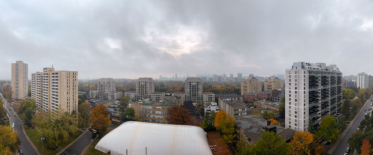 Flat grey cloud in drizzle, the skyline faint and low in contrast behind wet autumn colour.