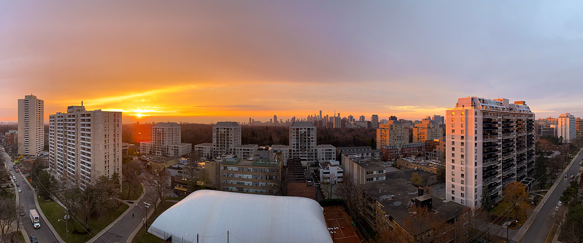 Orange fills the sky with the sun on the horizon and mauve at the right.