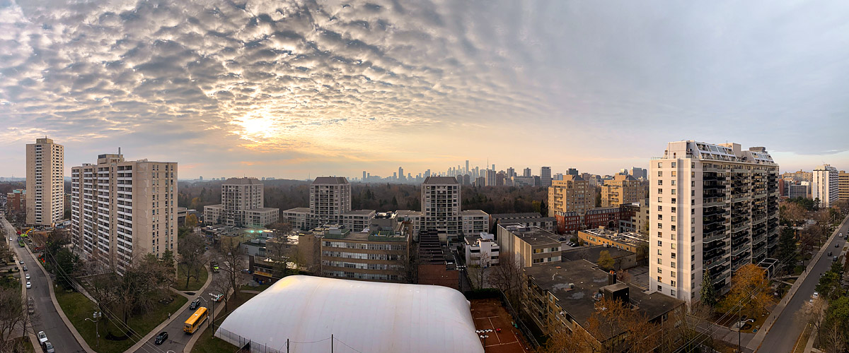 A deeply textured cloud deck covers the sky with warm light showing through the gaps to the left.