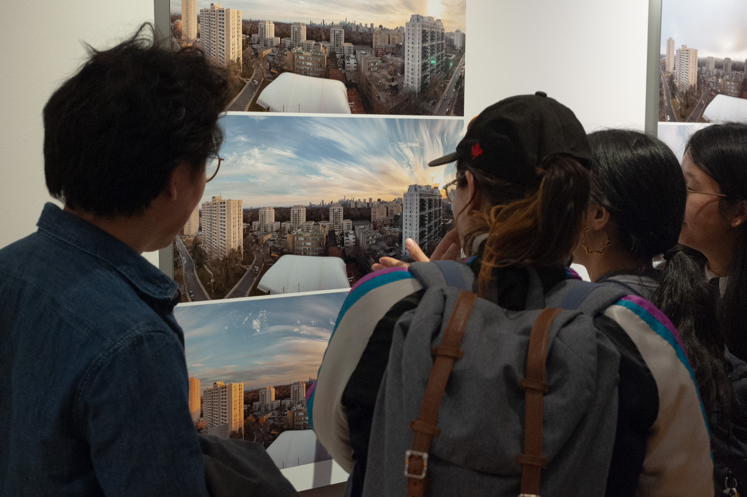 Visitors lean in close around a Shift.