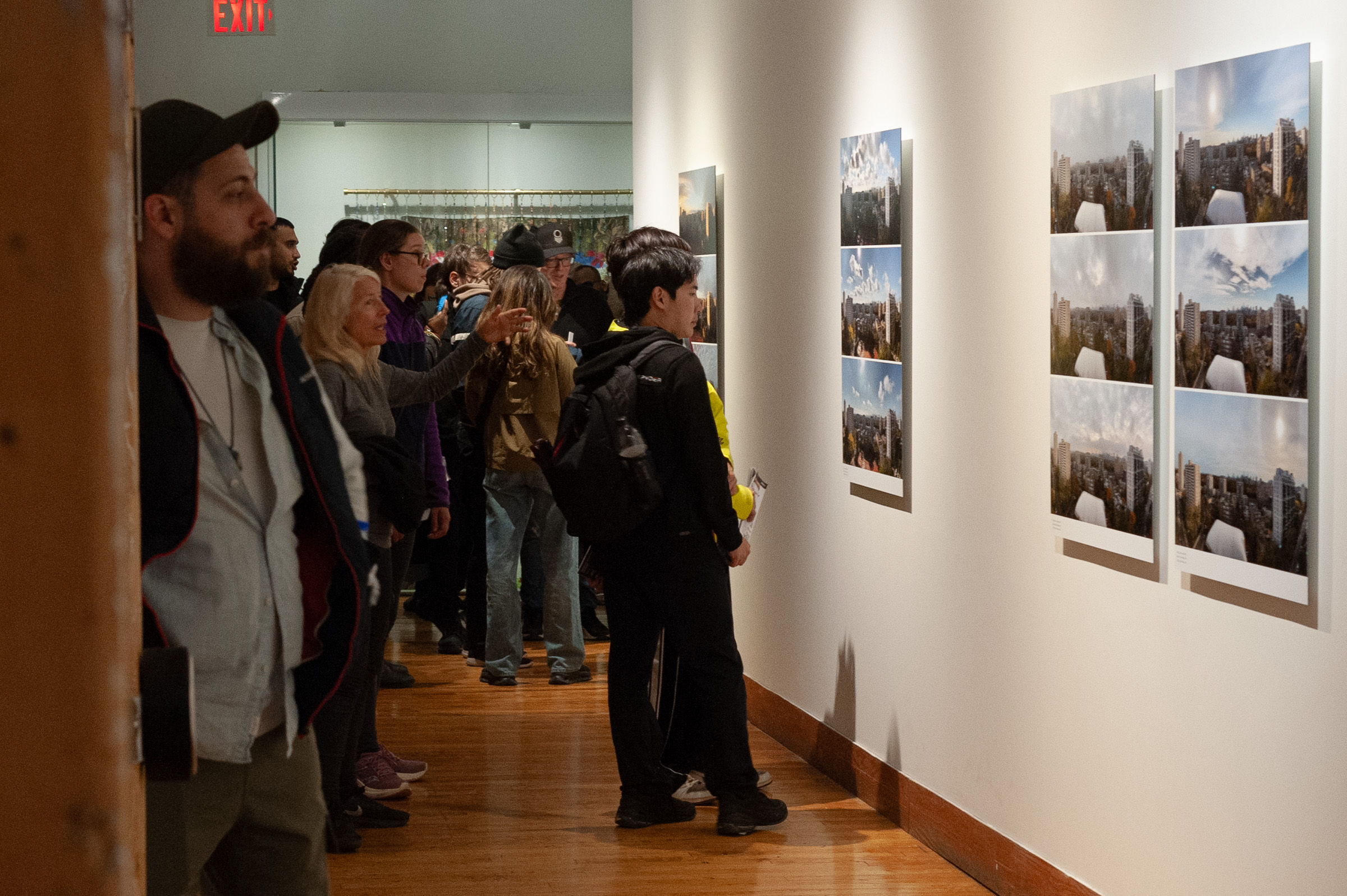 The full length of the corridor, visitors at the Shifts and a crowd at the far end.
