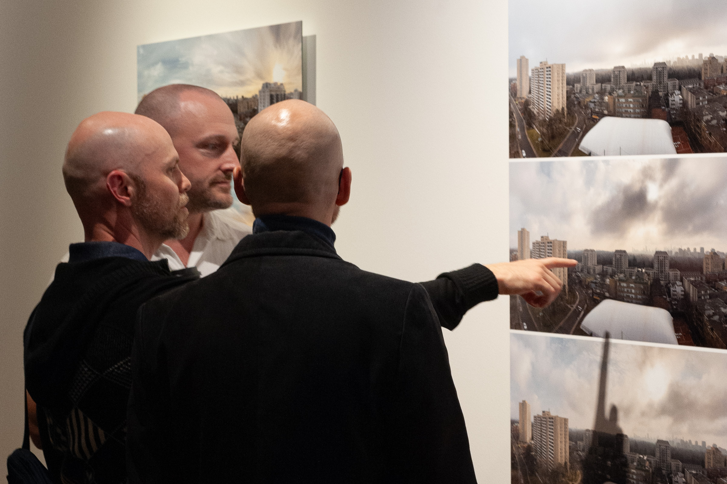 Three men stand at a Shift, one pointing to a place in the view.